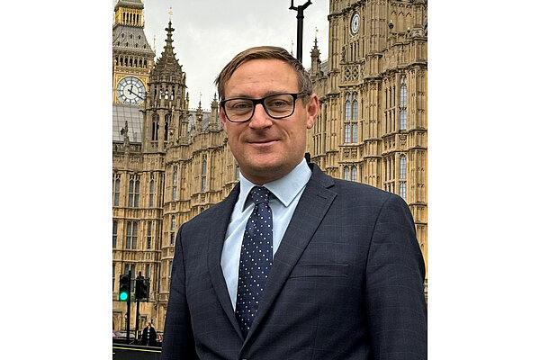 Olly Glover standing outside Parliament